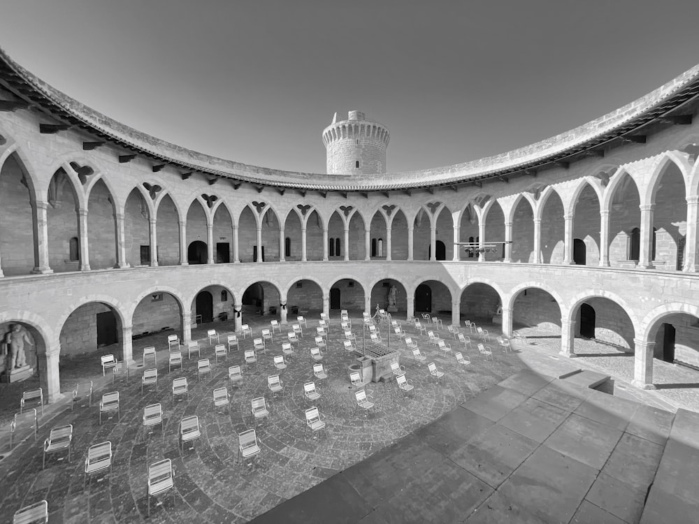 a circular room with chairs and a tower in the background