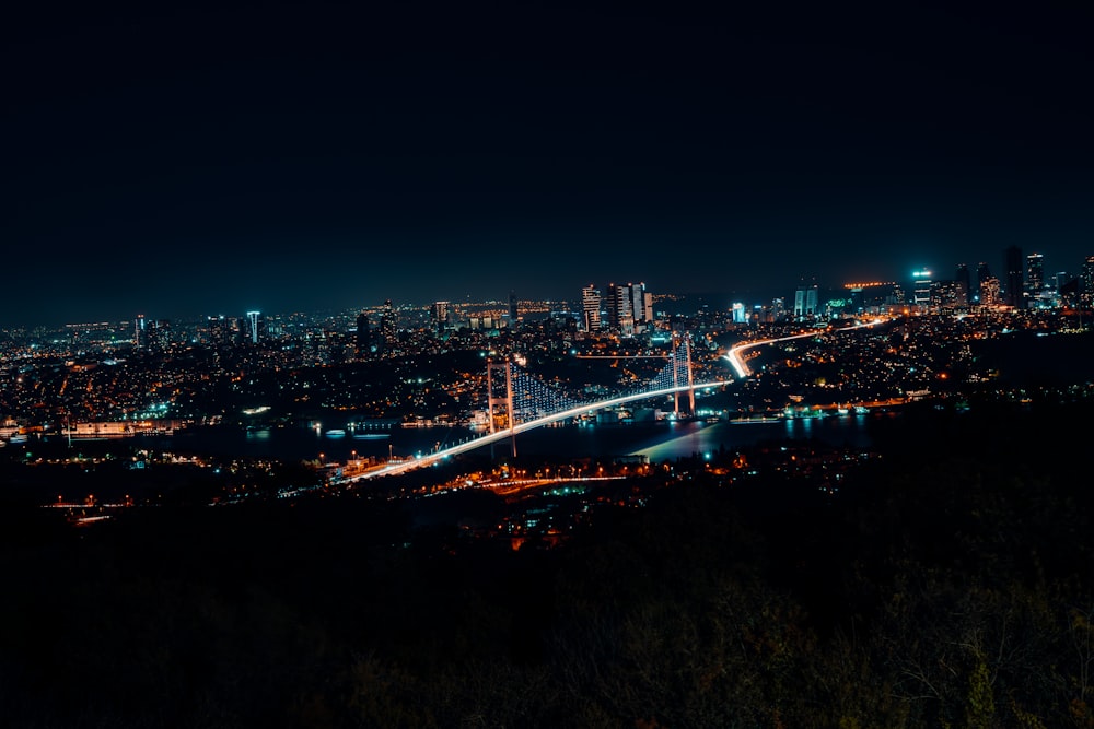 a view of a city at night from a hill