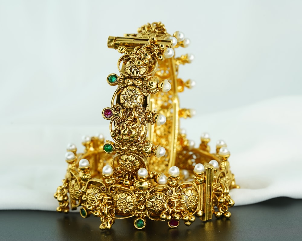 a close up of a gold bracelet on a table