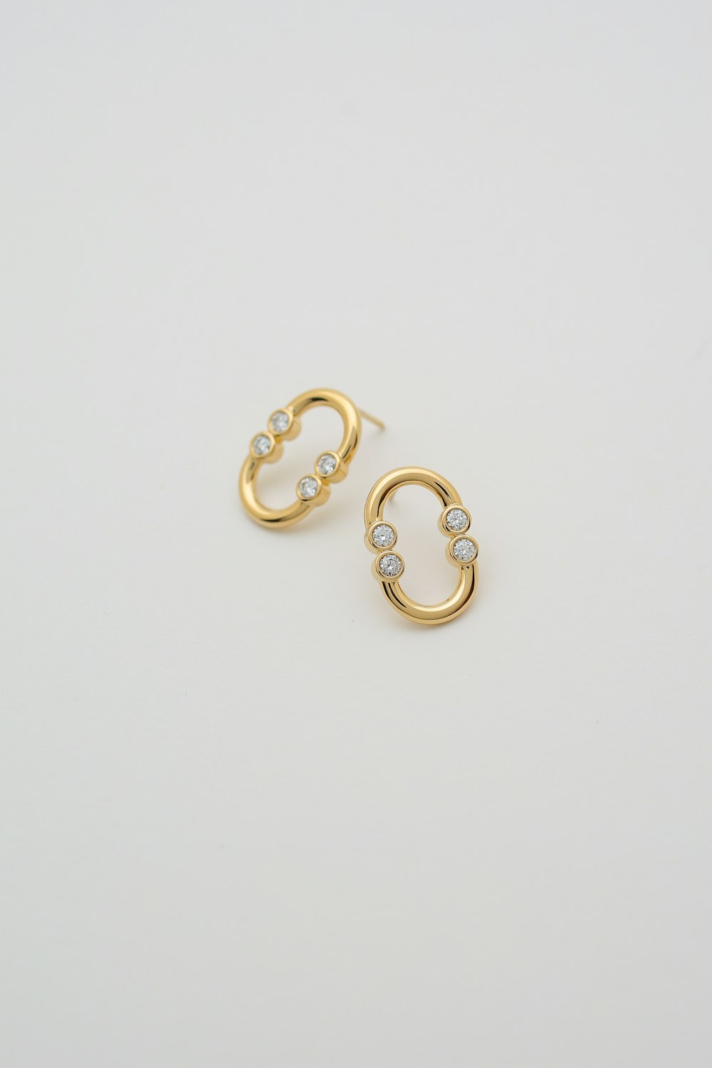 a pair of gold hoop earrings with diamonds