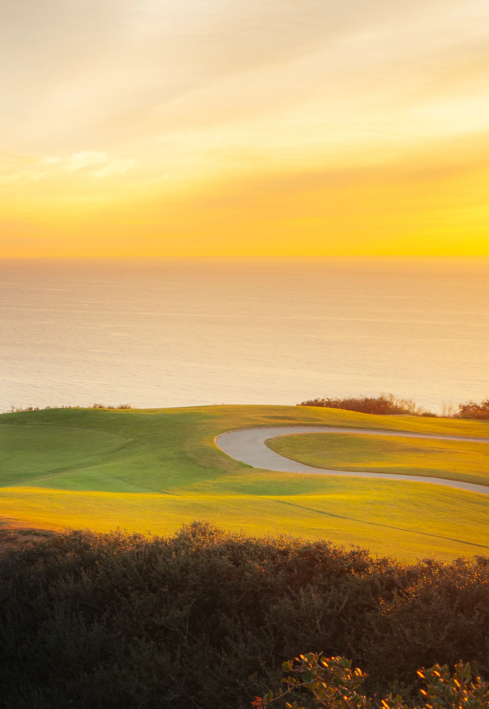 A golf course running down to the sea