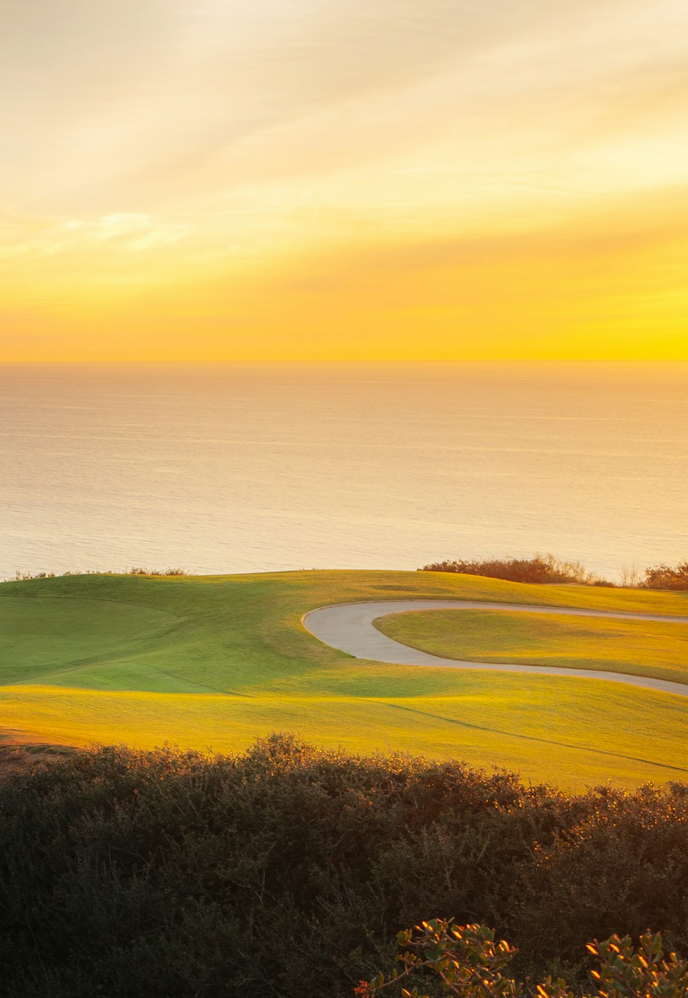 a golf course with a view of the ocean