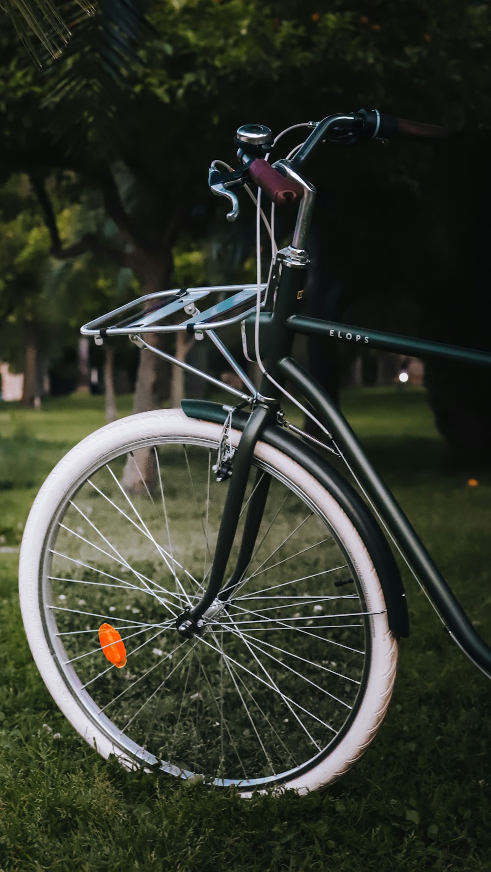 a close up of a bicycle parked in the grass