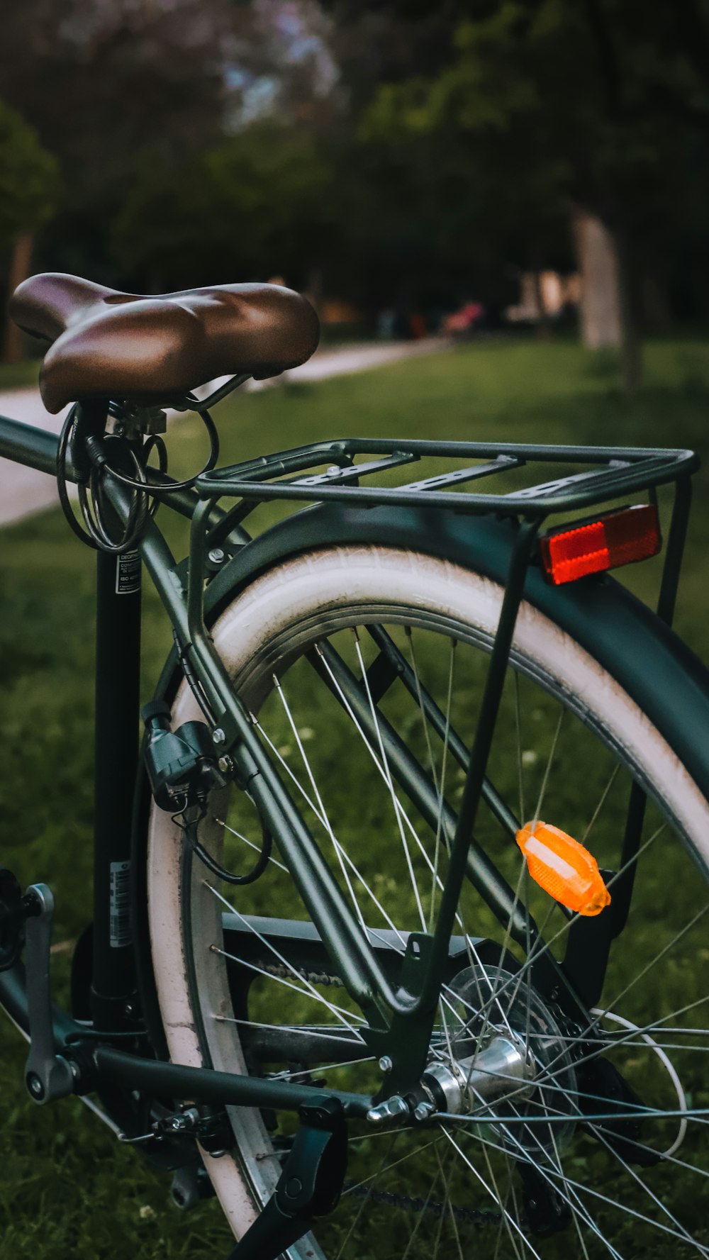 a close up of a bicycle parked in the grass