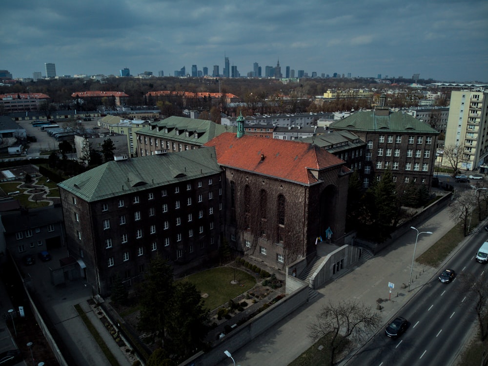 an aerial view of a large building with a red roof