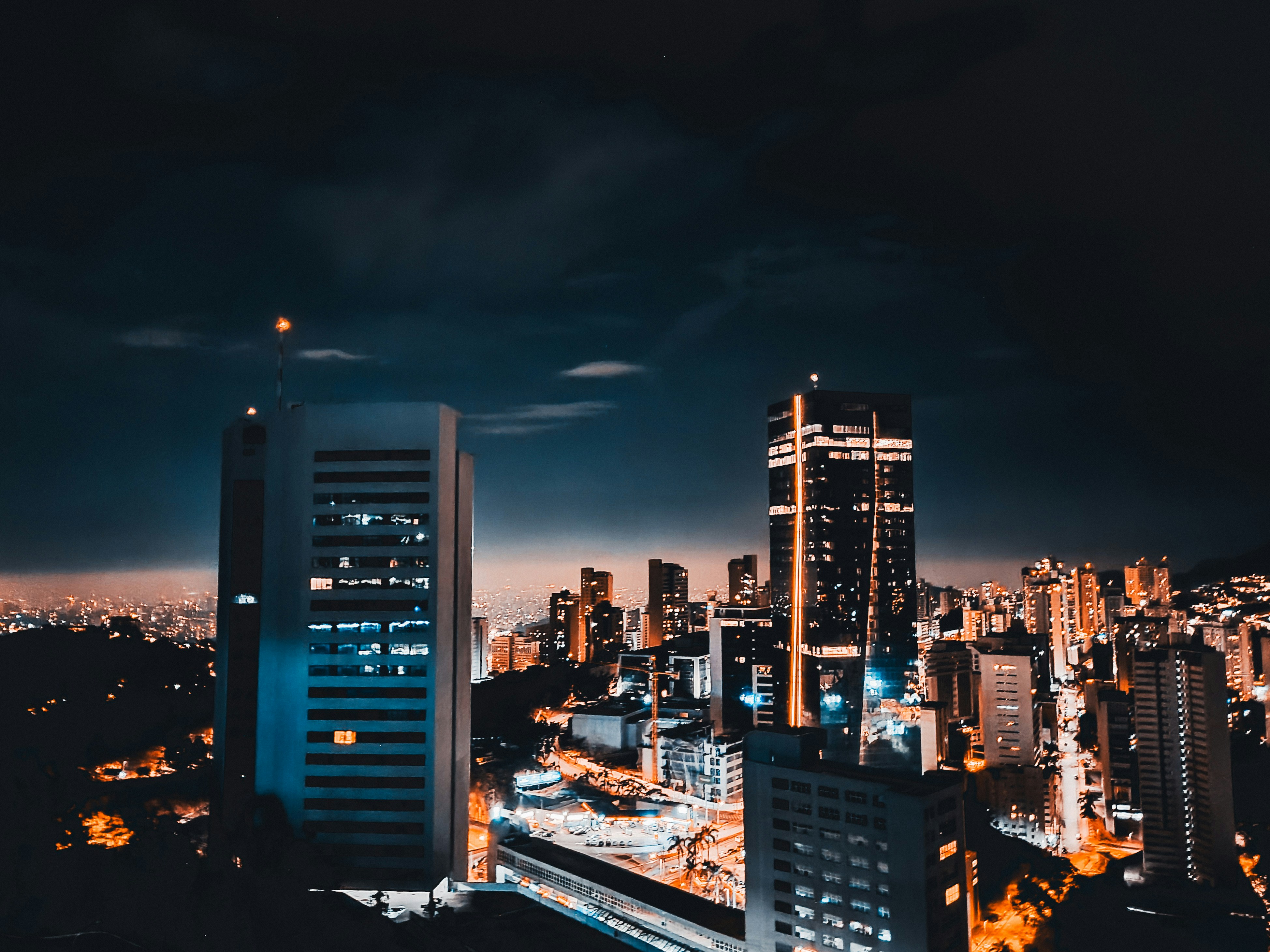 a view of a city at night from the top of a building