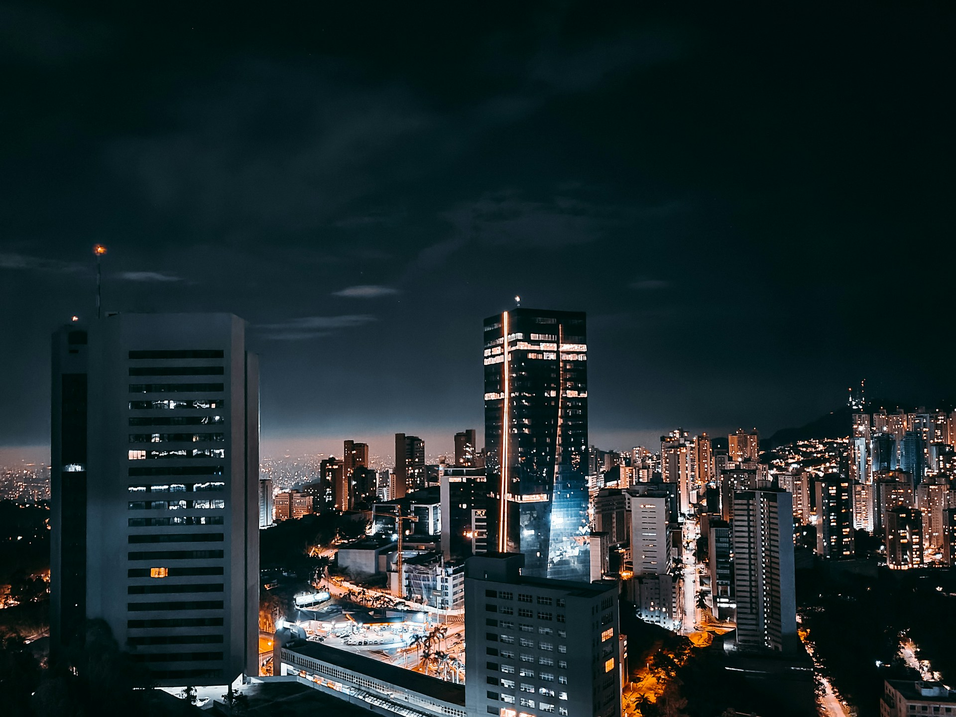 a city at night with a lot of tall buildings