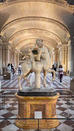 a statue of a man on a horse in a building