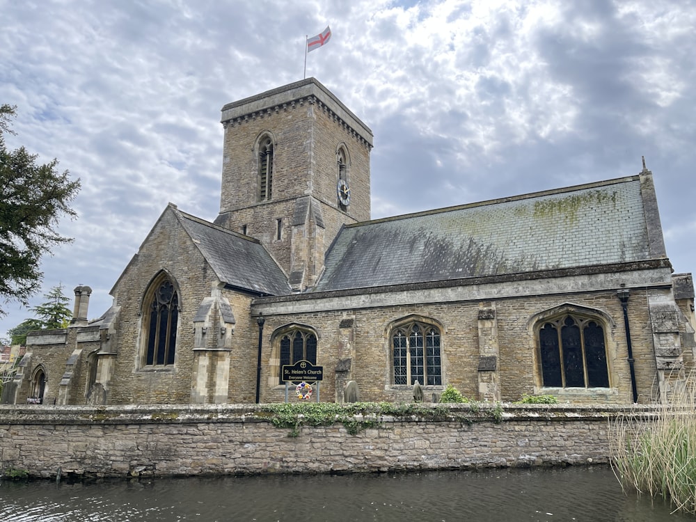 an old church with a moat in front of it