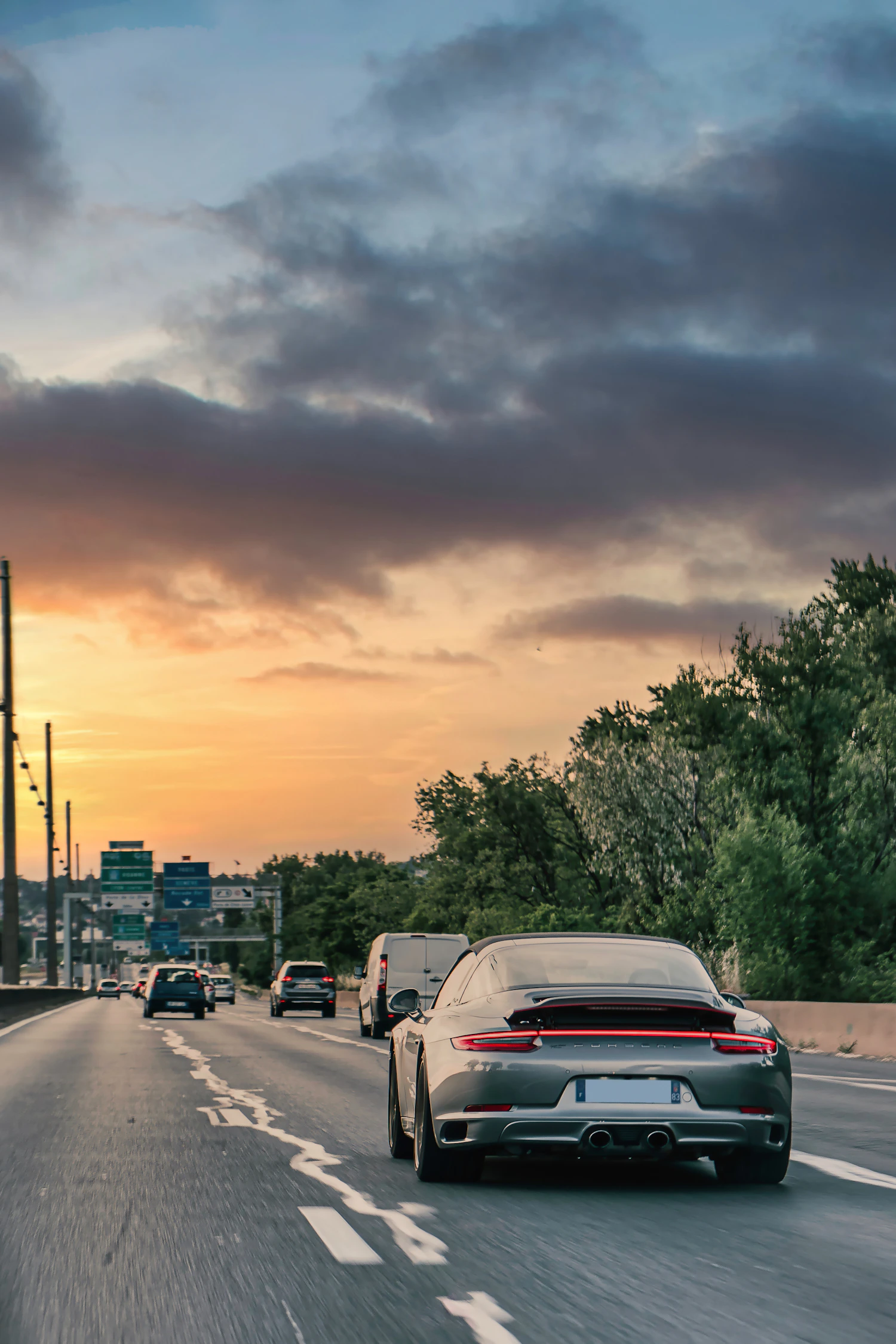 Vehicles travelling along a road at sunset