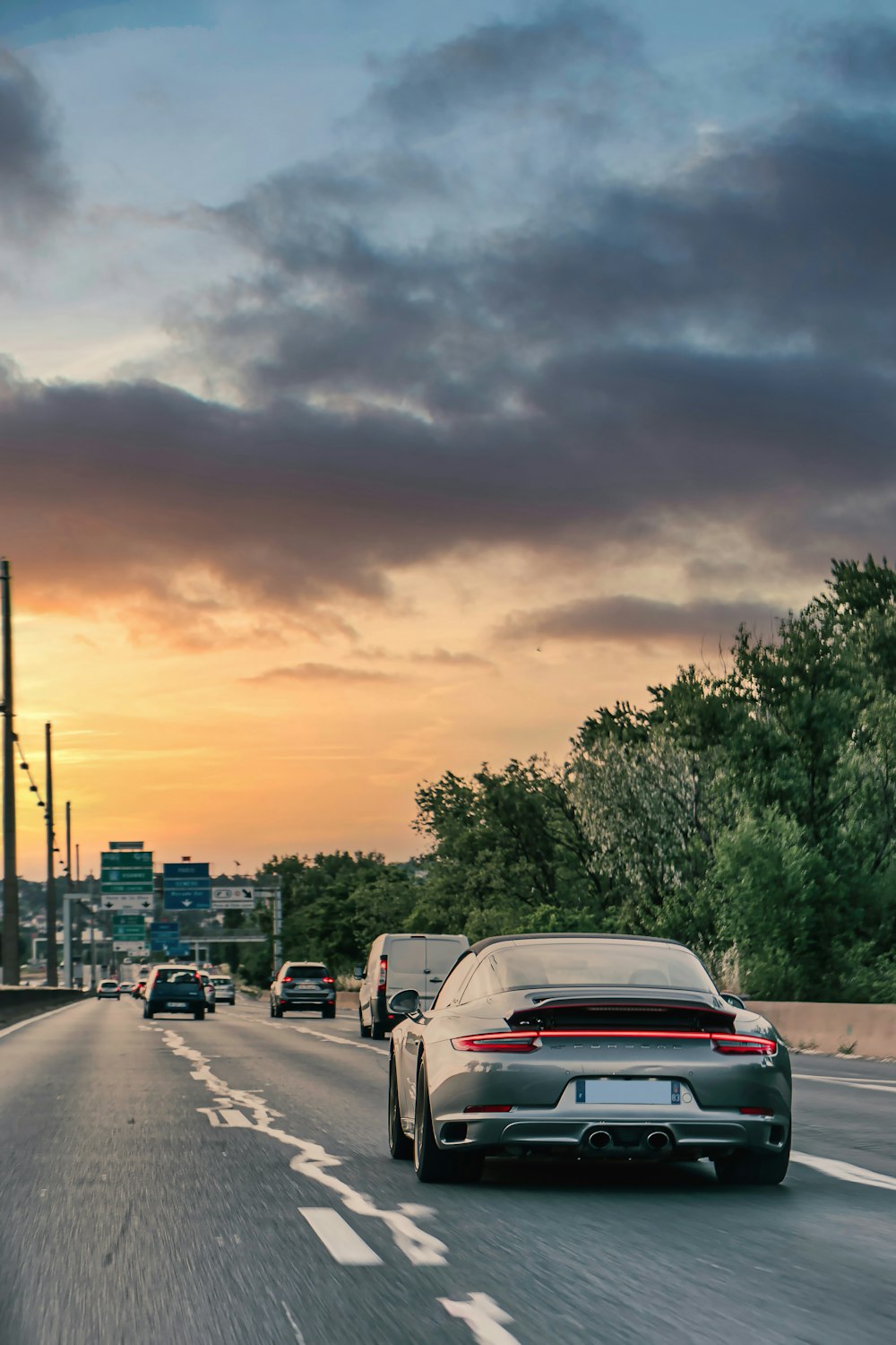 a couple of cars driving down a highway