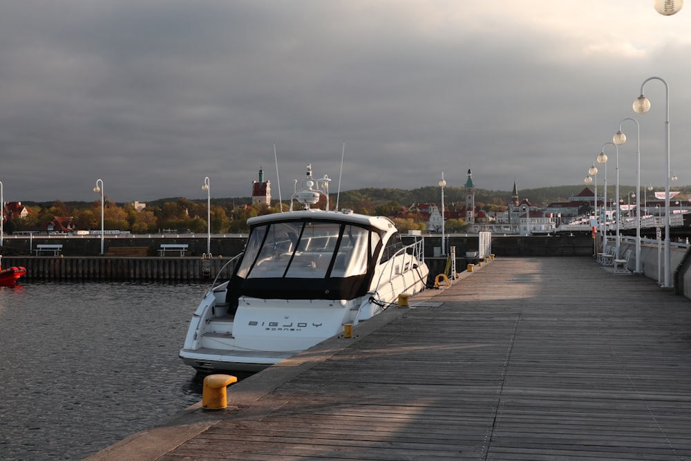 a boat is docked at a pier on a cloudy day