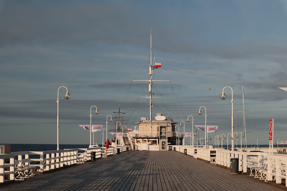 a boat docked at a pier on a cloudy day