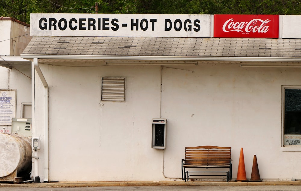 a white building with a sign that says groceries hot dogs