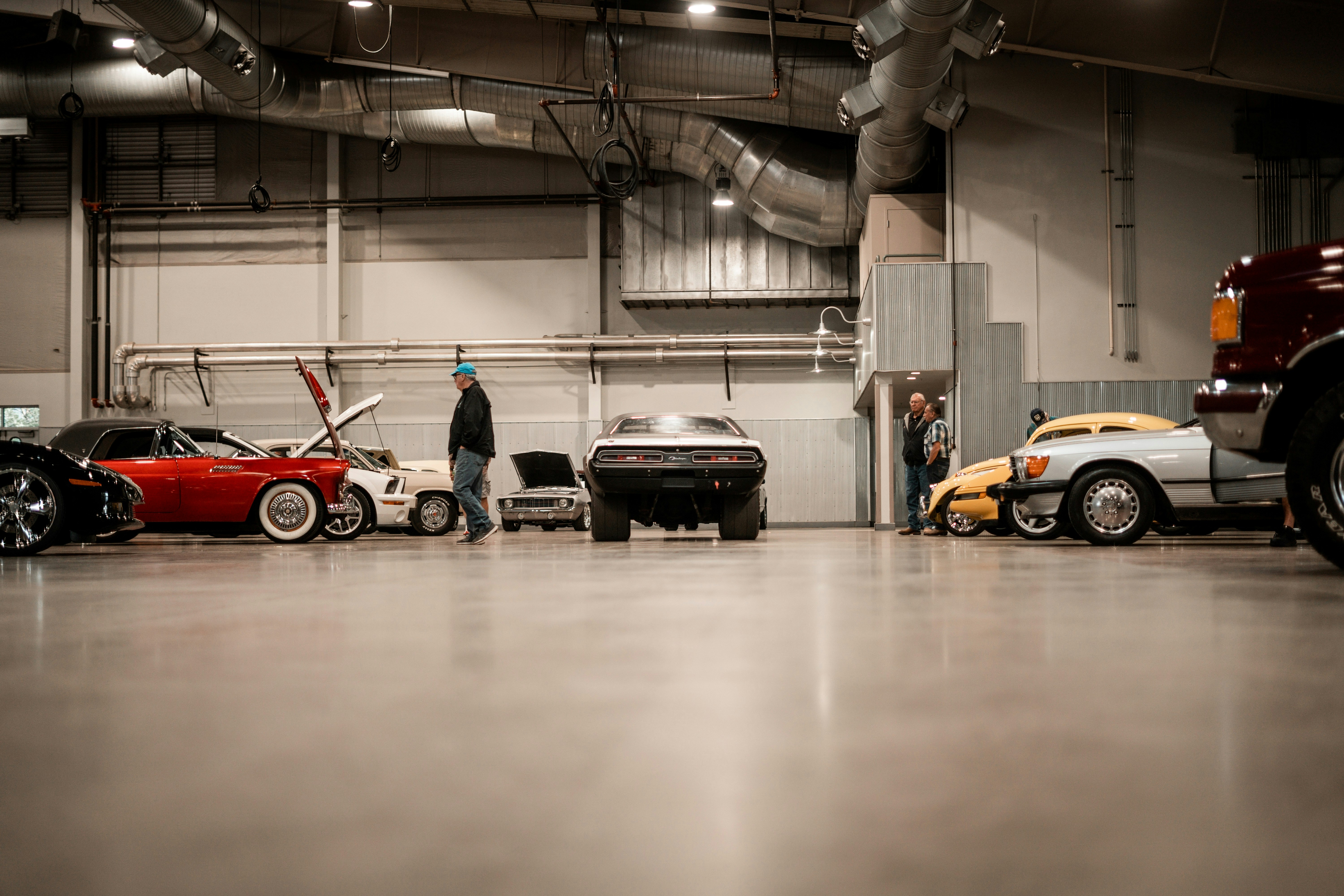Classic cars displayed in a large garage.