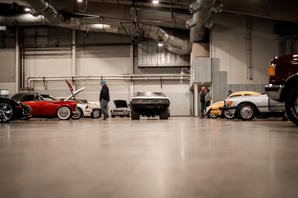 a man standing next to a row of parked cars