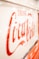 a close up of a coca cola sign on a car