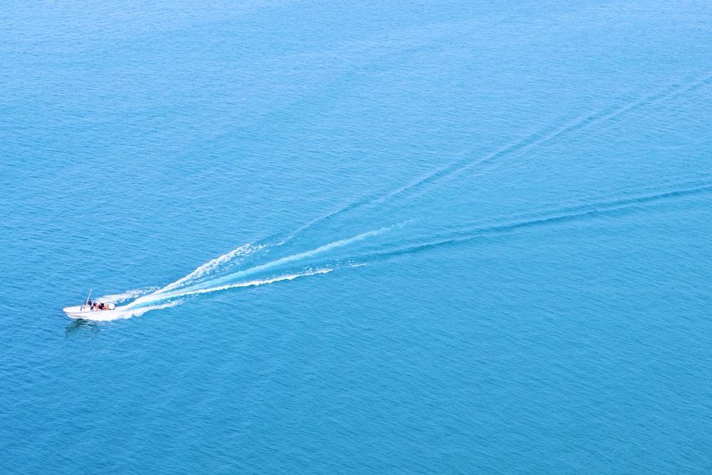 a small boat is speeding across the water