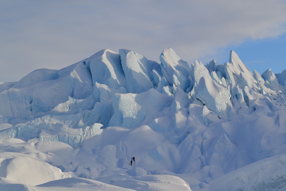 a man standing on top of a snow covered mountain