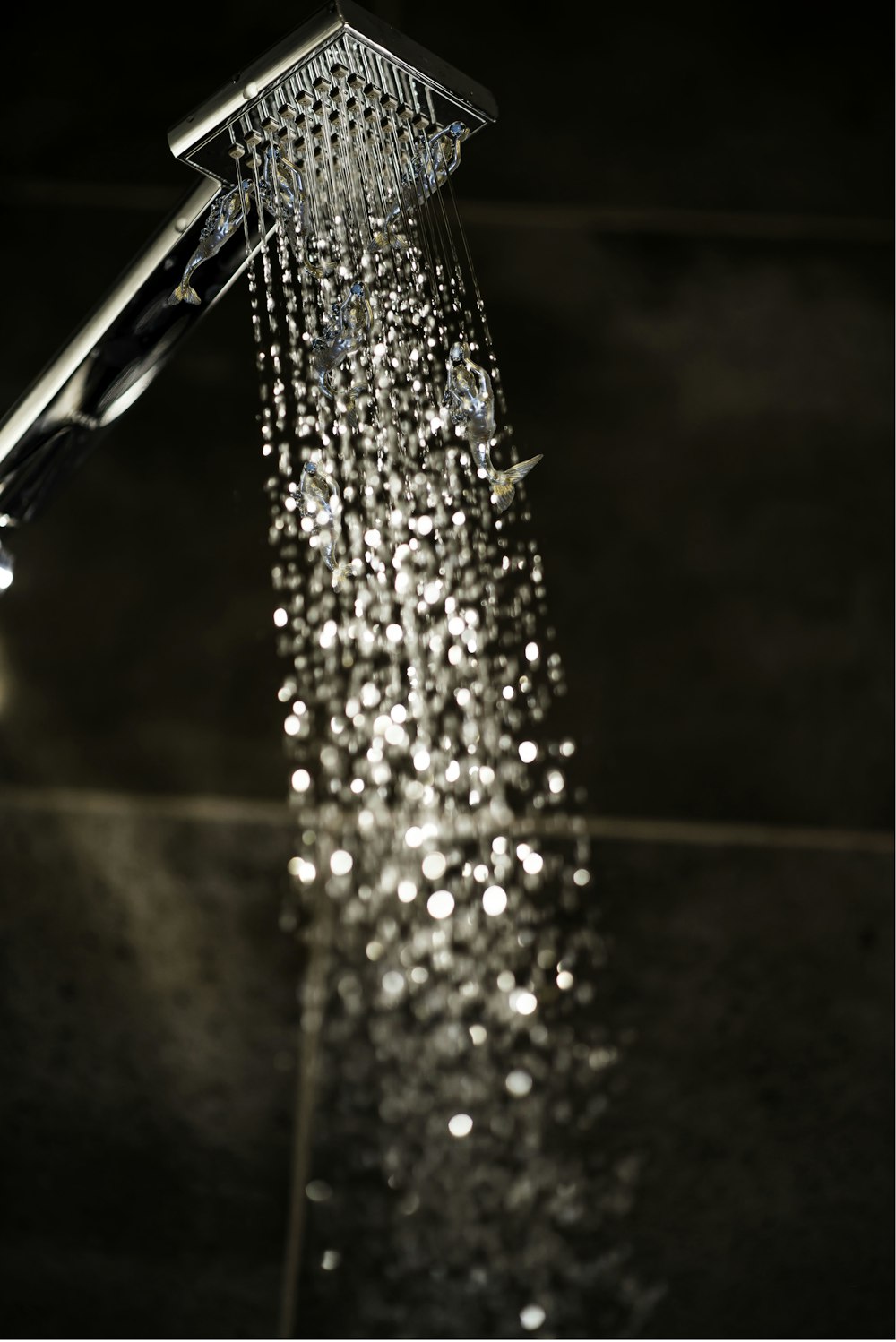 a close up of a shower head with water coming out of it