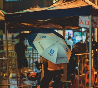 a person on a bike with an umbrella