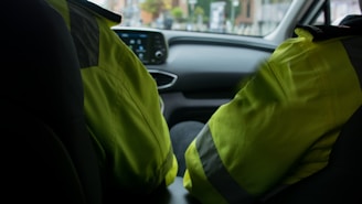 a person in a car wearing a safety vest