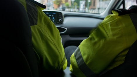 a person in a car wearing a safety vest