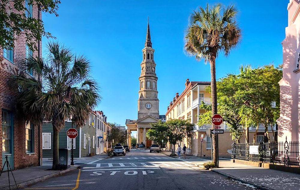 a street with a church steeple in the background