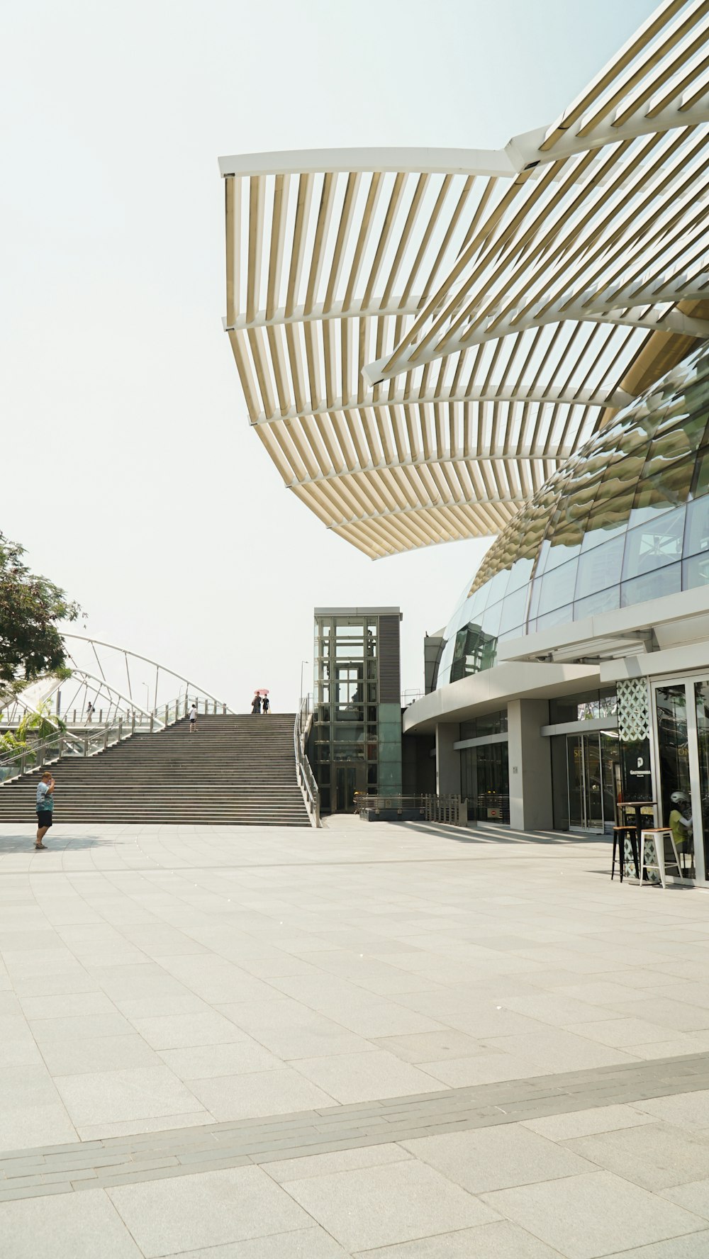 a man riding a skateboard down a sidewalk next to a tall building