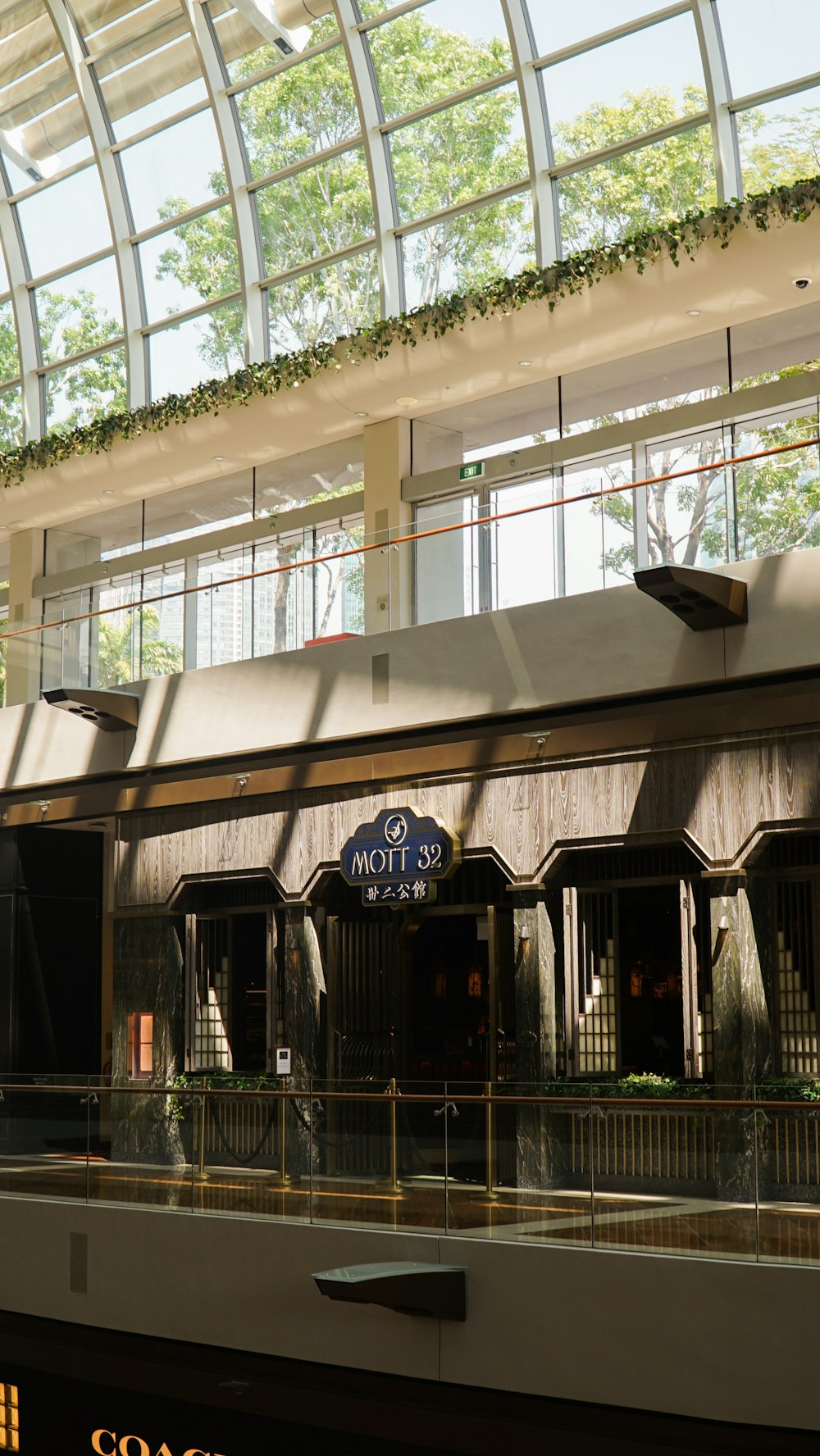 a building with a glass roof and a clock on it