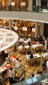 A bustling scene of people enjoying coffee and desserts in a two-level café.