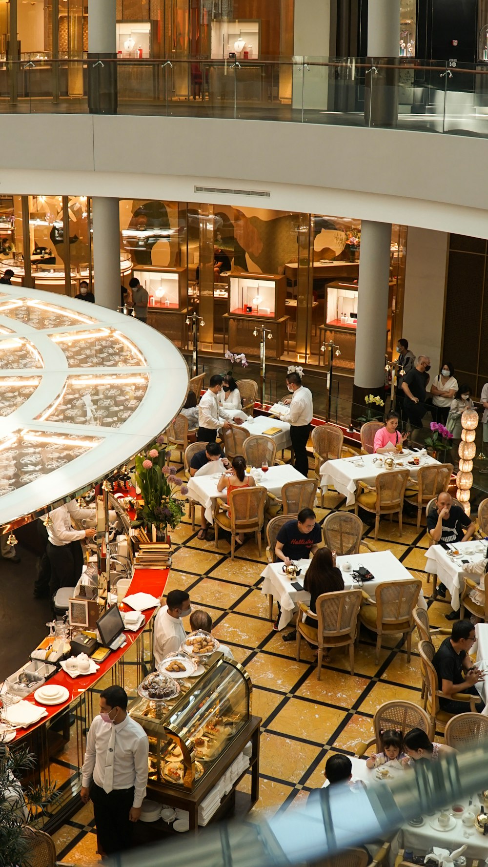 a group of people sitting at tables in a restaurant