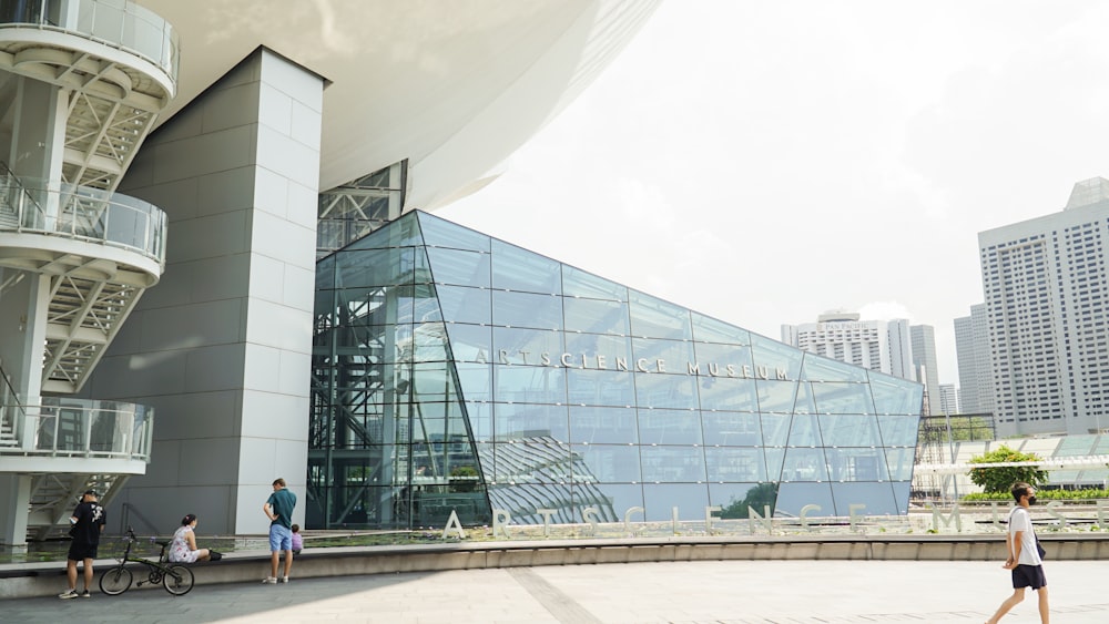 a group of people walking around a building