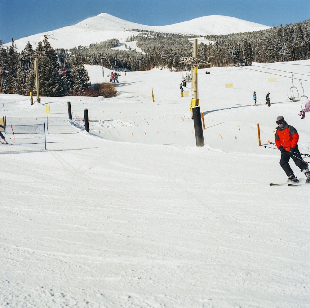 a man riding skis down a snow covered slope