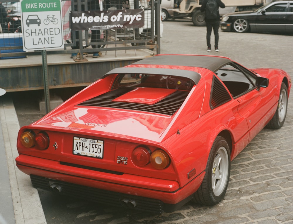 a red sports car parked on the side of the road