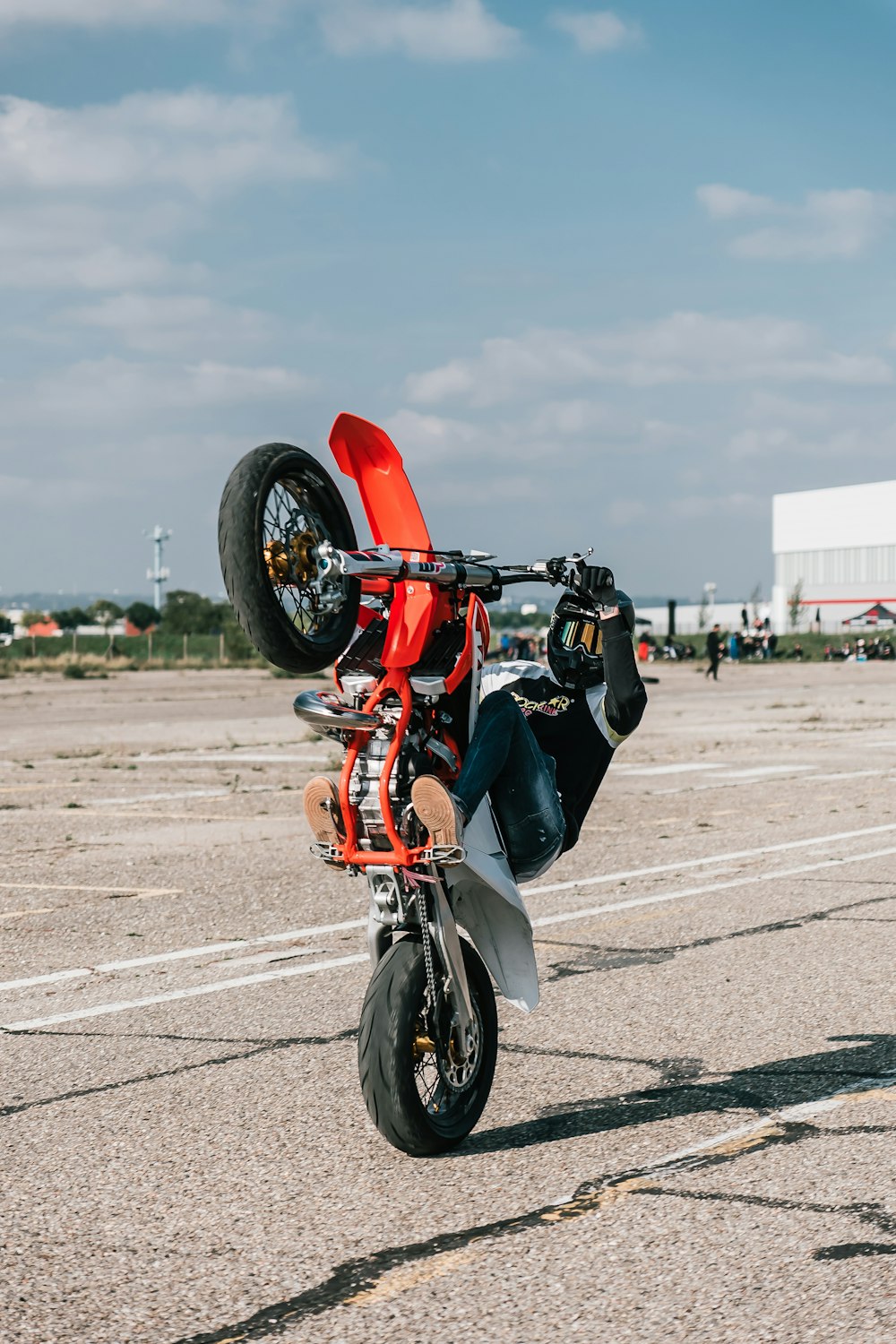 a man is doing a wheelie on a motorcycle