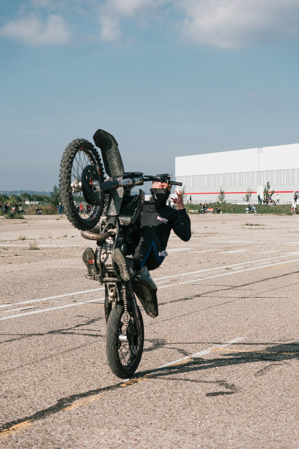 a man doing a wheelie on a motorcycle