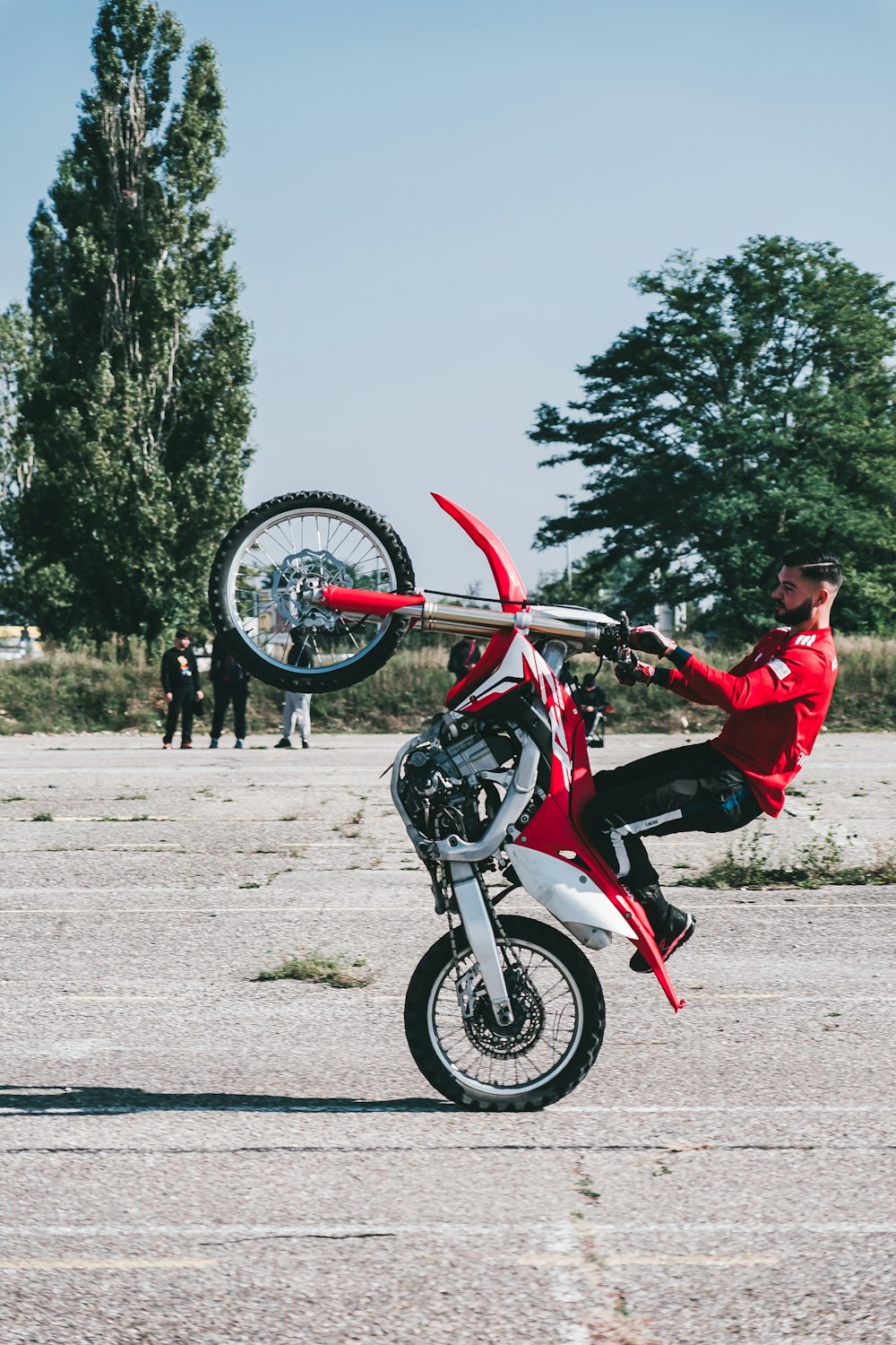 a man is doing a wheelie on a motorcycle