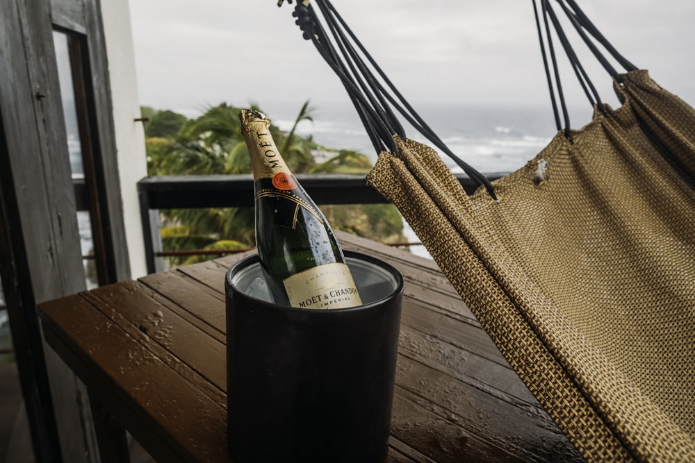 a bottle of champagne sitting in a hammock