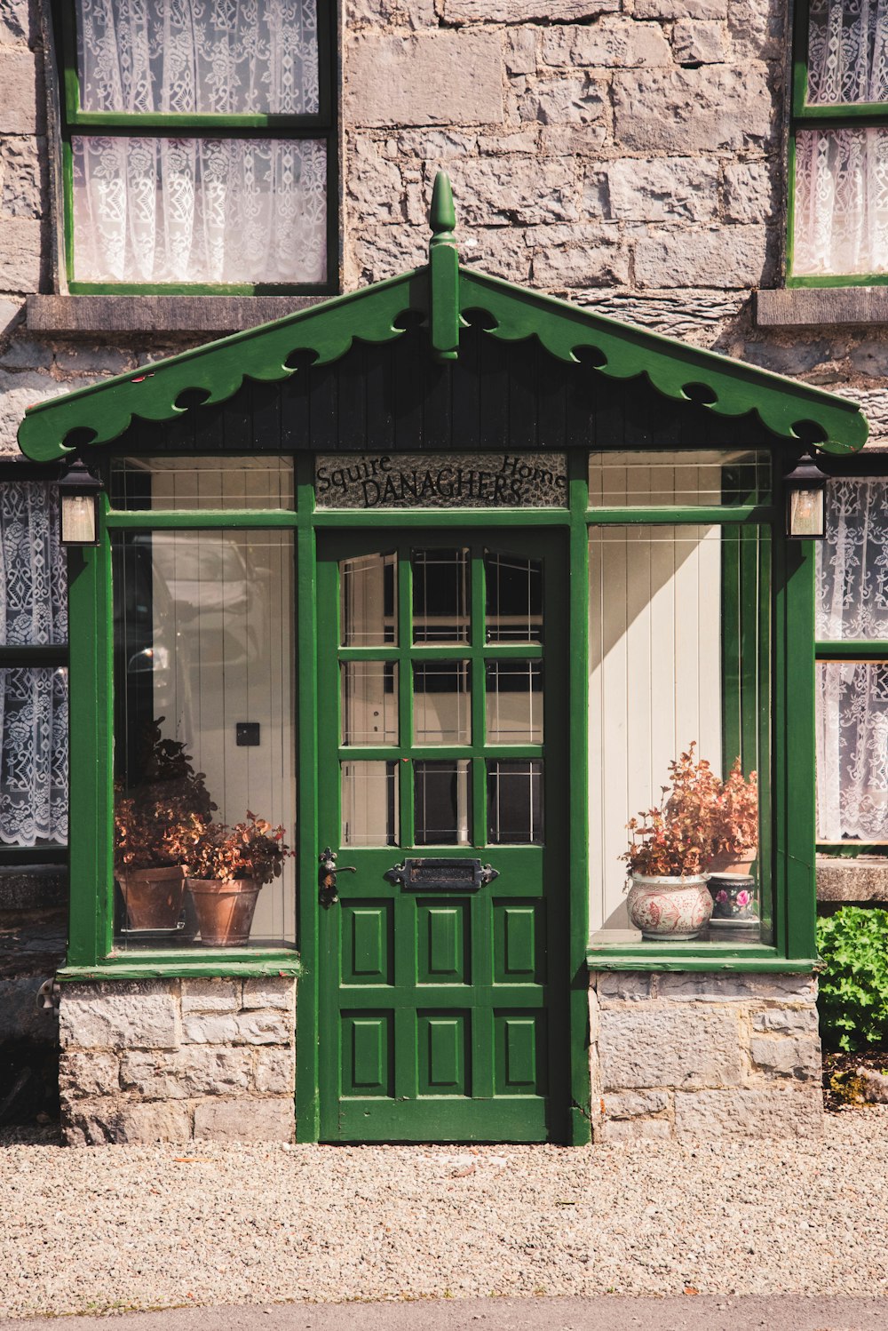 a building with a green door and windows