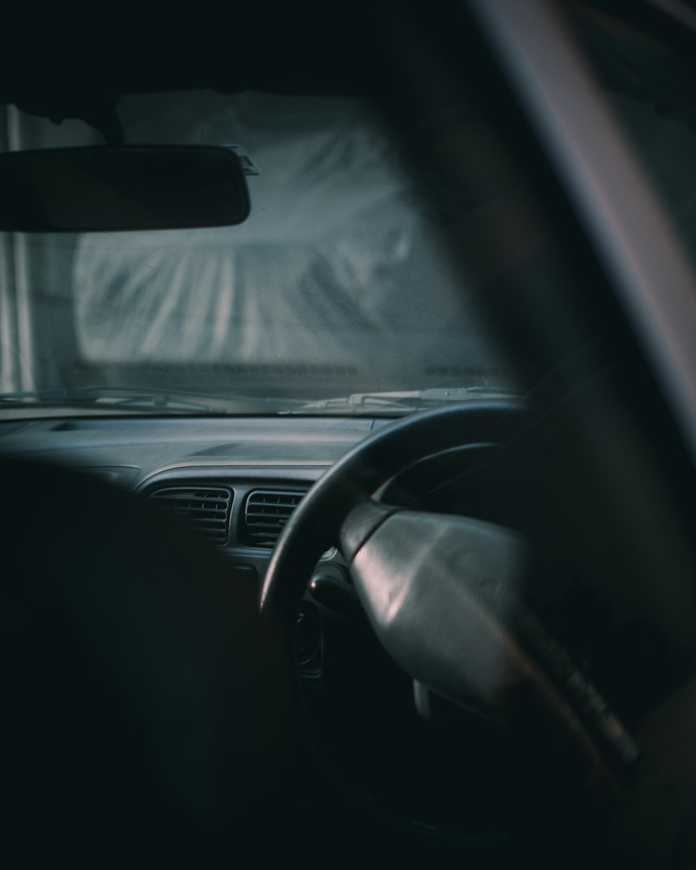 a car dashboard with a steering wheel and dashboard lights