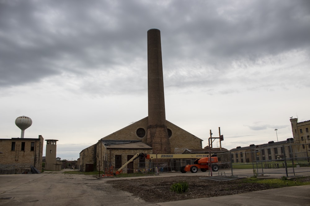 a factory building with a large chimney in the middle of it