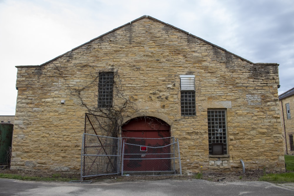 an old brick building with a red door