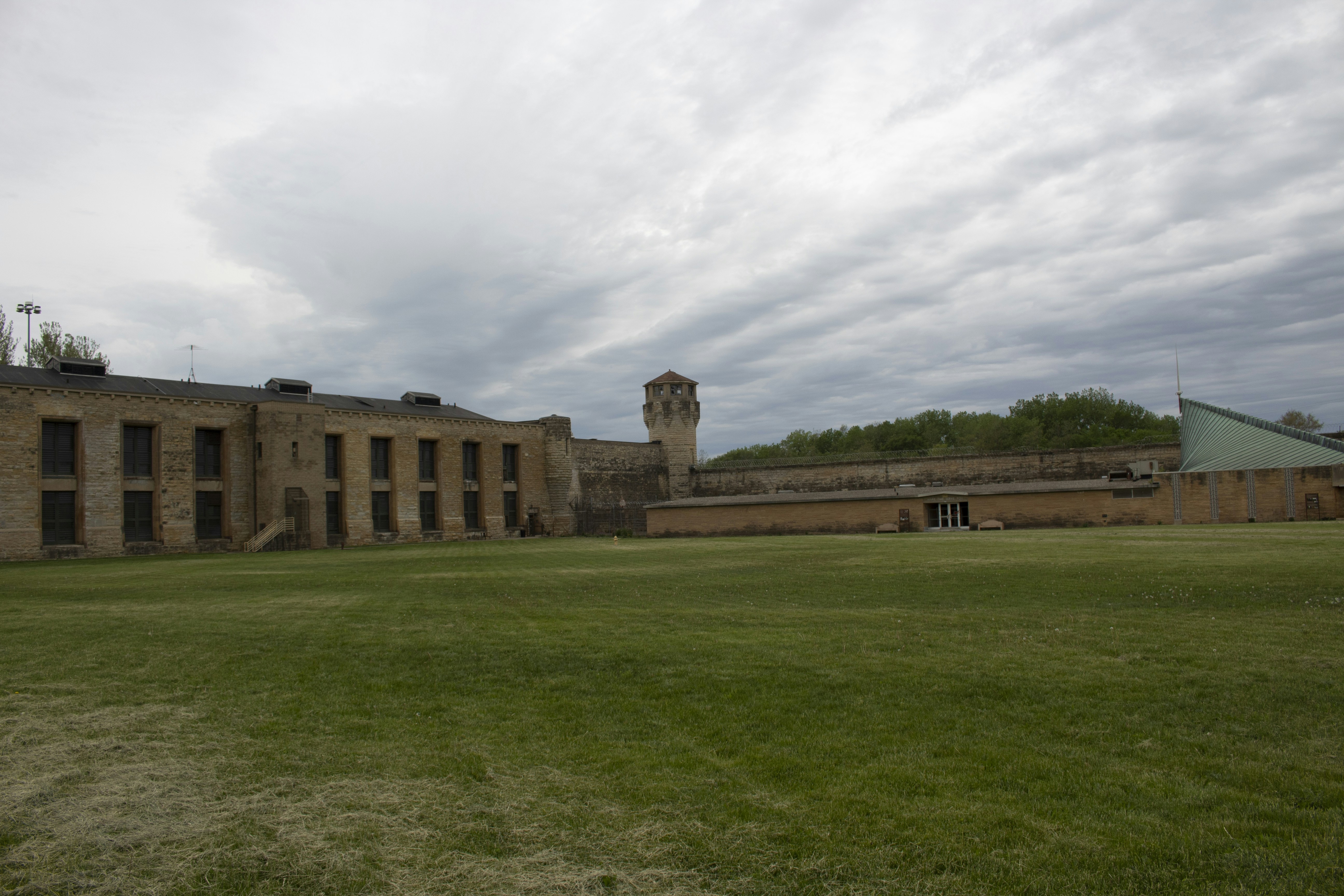 建物を背景にした広い草原の写真 Unsplashの無料古いジョリエット刑務所写真