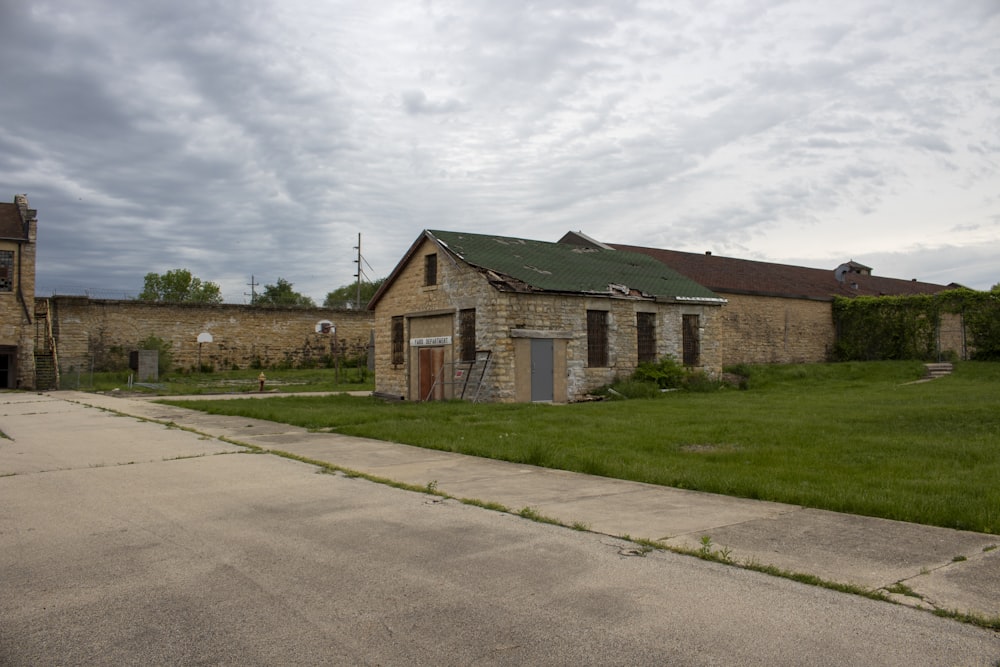 an old run down building with a green roof