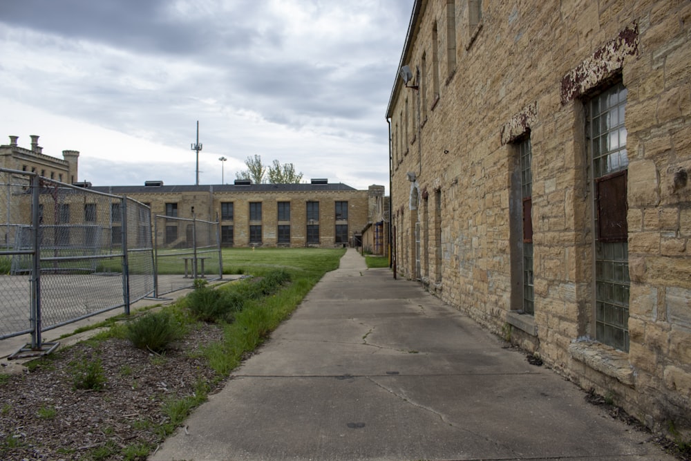 an old brick building with a chain link fence