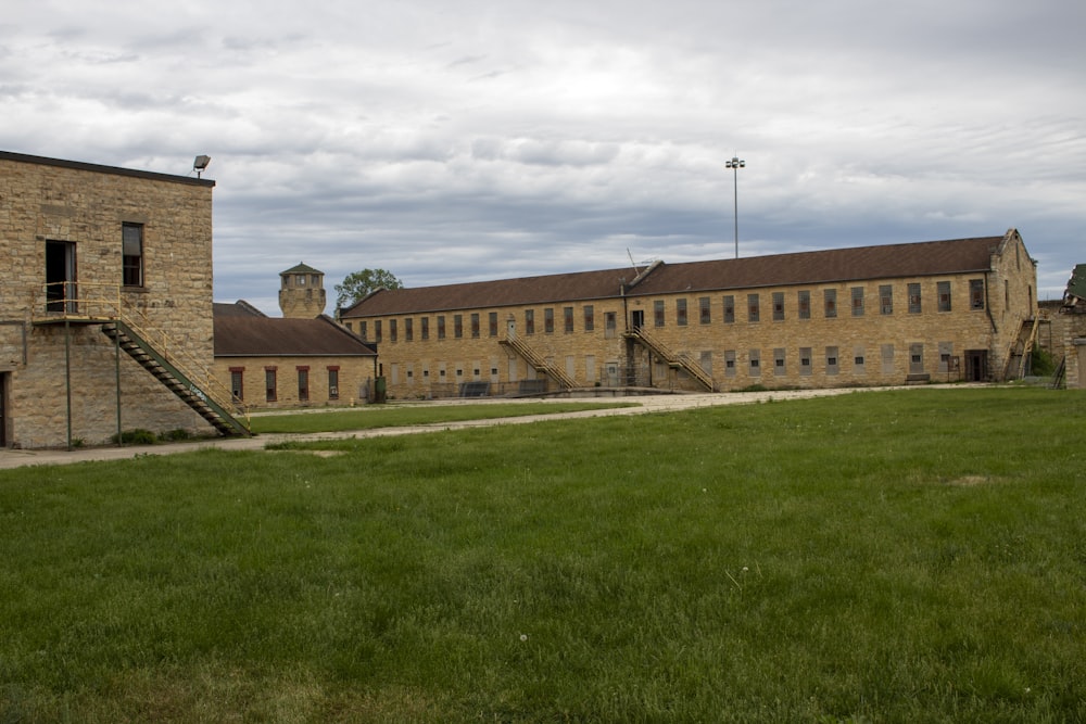 a large building with a grassy field in front of it