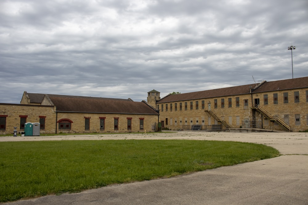 a large building with a green lawn in front of it