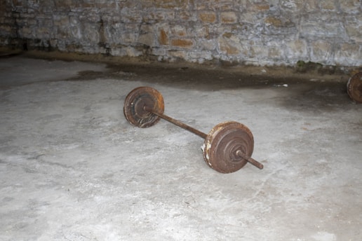 A close-up of rusty gym weights stacked together, showcasing their vintage charm.