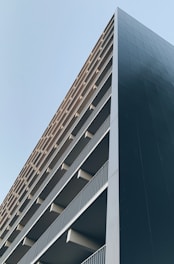 a tall building with balconies on top of it